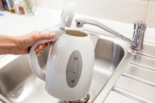 Pouring water into an electric kettle